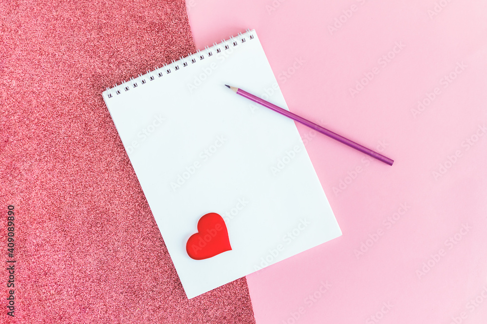 Notebook with blank page, pencil and red heart on a pink background. Notebook with blank page, pencil and red heart on a pink background.