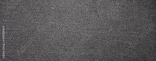 The texture of dark gray fabric is fluted in stripes.Background of dense gray fabric. photo