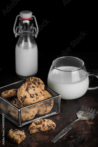 Chocolate Chip Cookies and milk on dark