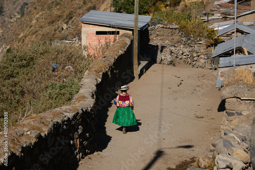 A minority walking in an alley in Llamac village on the Cordillera Huayhuash circuit  Ancash  Peru