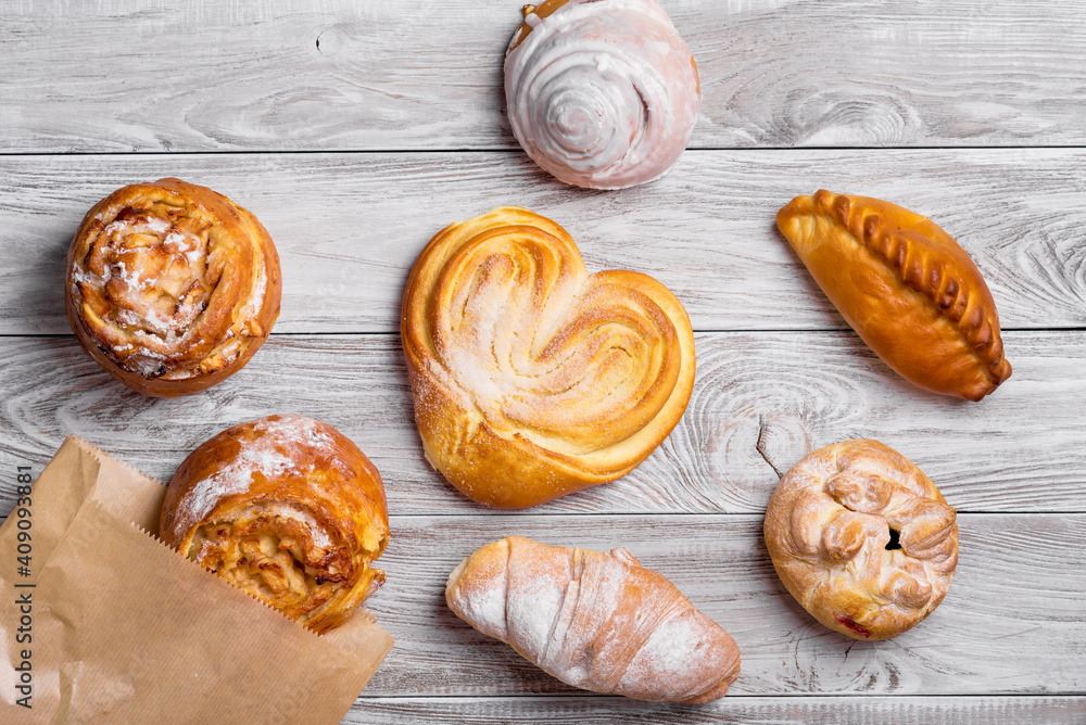 Fototapeta premium delicious sweet browned cakes bakery products on wooden table.