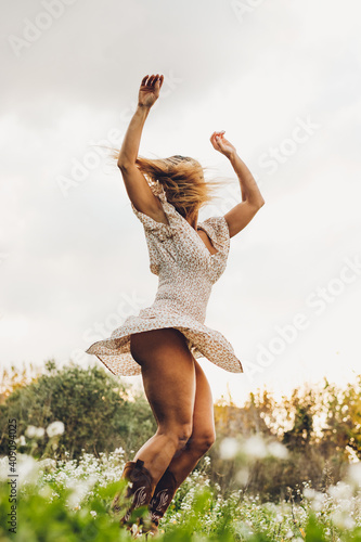Woman Dancing In Nature With Hair On Her Face photo