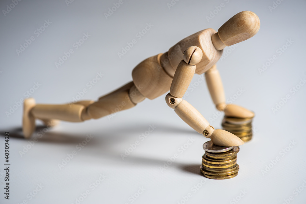 Business Concept . Wooden man and stacked coins isolated on background. Business Concept . Wooden man and stacked coins isolated on background.