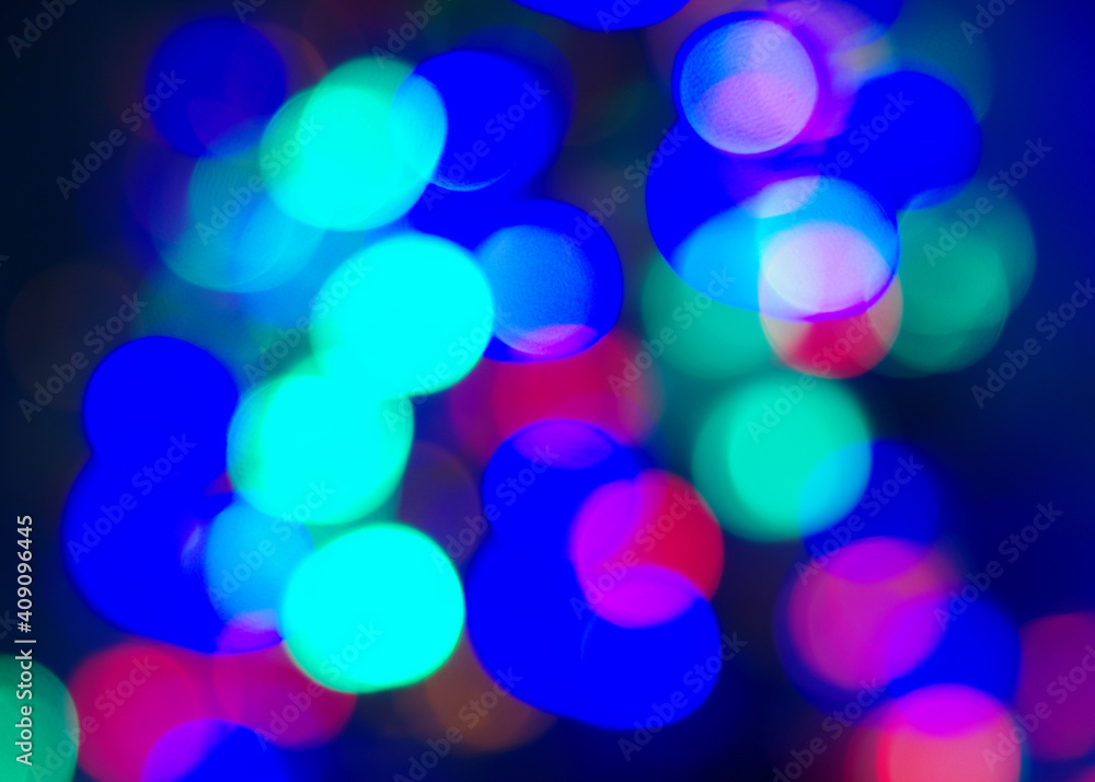 Bokeh blue background. Bright festive multicolored circles and lines in motion. Defocused abstract colorful lights Bokeh blue background. Bright festive multicolored circles and lines in motion. Defocused abstract colorful lights
