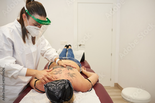Masseur massages a woman's back. photo
