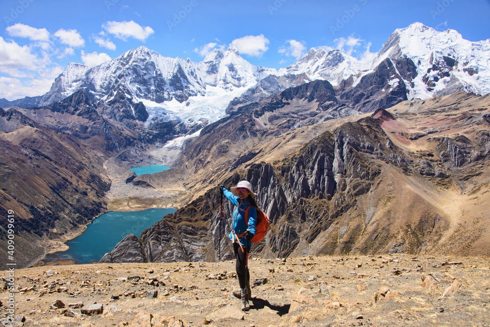 Happy trekker enjoying the view of Laguna Jahuacocha and the entire Cordillera Huayhuash, Ancash, Peru.