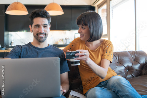 Young couple shopping online from home.