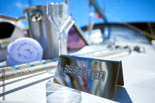 Wallpaper Mural Romantic luxury evening on cruise yacht with champagne setting. Empty glasses and bottle with champagne and tropical sunset with sea background Torontodigital.ca