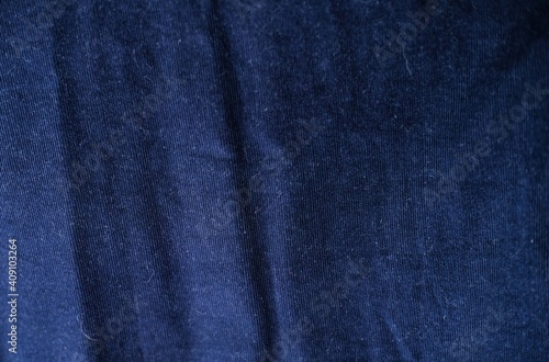 Dark blue velvet surface background. Detailed macro shoot of velveteen velour.
