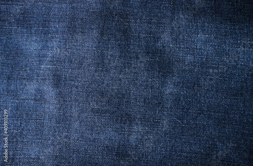 Macro shot of blue denim, jean. Modern dress textile, detailed fashion material.
