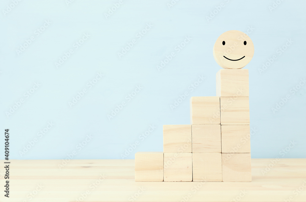 Concept image of satisfaction level. wooden cubes with emotions