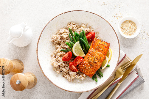 Photography Salmon fish fillet baked, rice, green beans and tomatoes in lunch bowl