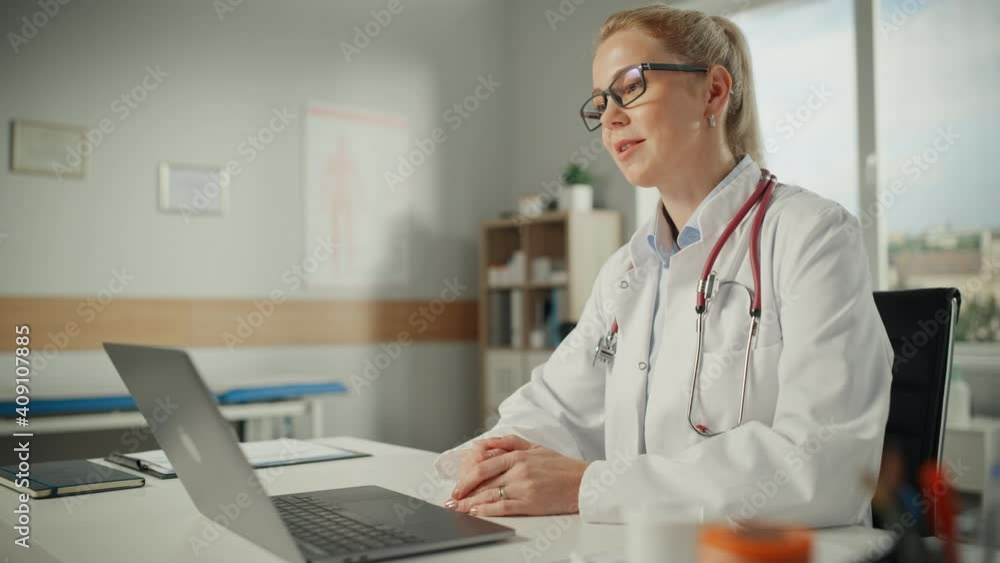 Doctor's Online Medical Consultation: Caucasian Female Physician is Making a Conference Video Call with a Patient on a Laptop Computer. Health Care Professional Giving Advice, Explaining Test Results. Doctor's Online Medical Consultation: Caucasian Female Physician is Making a Conference Video Call with a Patient on a Laptop Computer. Health Care Professional Giving Advice, Explaining Test Results.