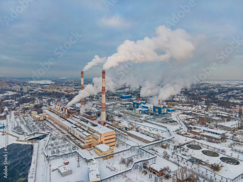 Aerial view of pipes of industrial factory. Steam smoke production energy complex profession contamination. Climate change and global warming
