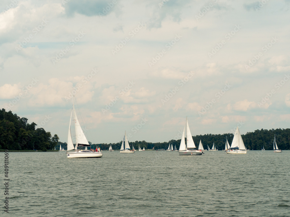 Beldany lake, Masuria, Poland, 28 of July 2020. Listed yachts sailing during windy summer day.