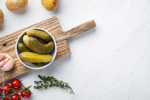 Homemade canning. Marinated cucumbers gherkins, on white background, top view flat lay , with space for text  copyspace photo