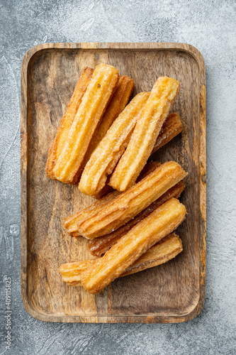 Churros with chocolate Traditional Spanish cusine, on gray background, top view flat lay