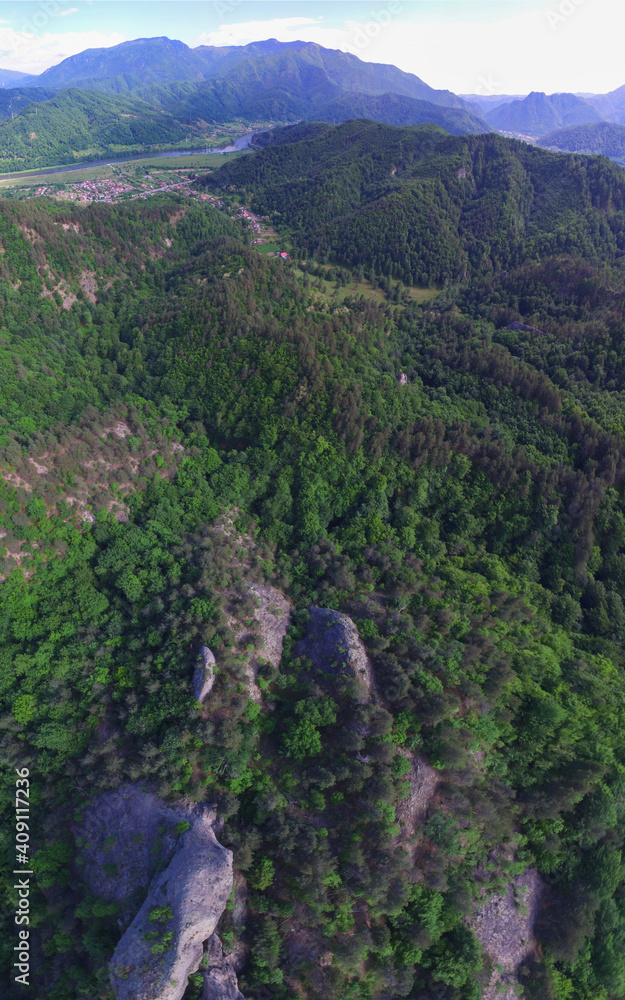 Aerial drone vertical panorama of Cozia Mountains and Olt Valey seen from a rocky hill top near Calinesti village. Carpathia, Romania.