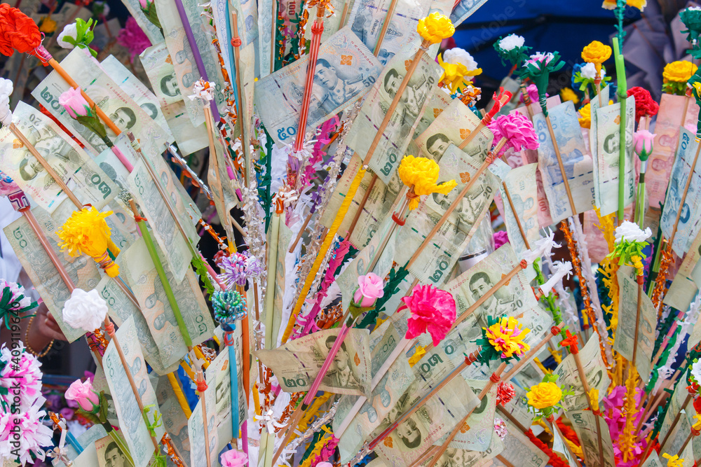 Thai Buddhist make a merit with bank note