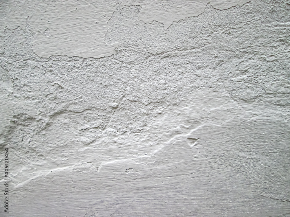 Obraz premium Rough white surface on the wall. Whitewashing a room in the house. Old photo effect.