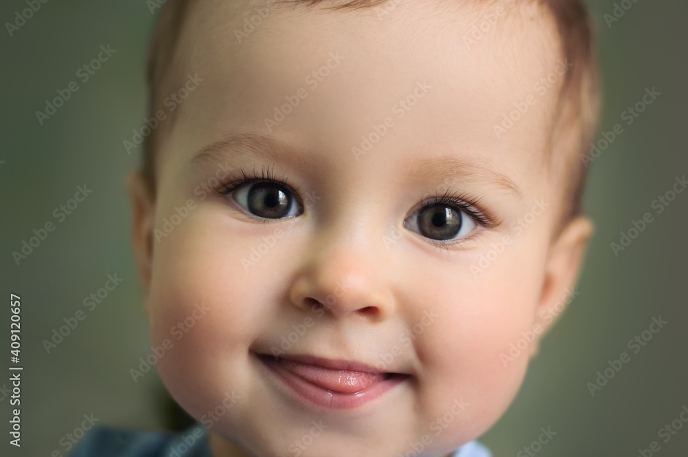 Baby showing tongue. Kid smiling, close up. Children's emotions Baby showing tongue. Kid smiling, close up. Children's emotions