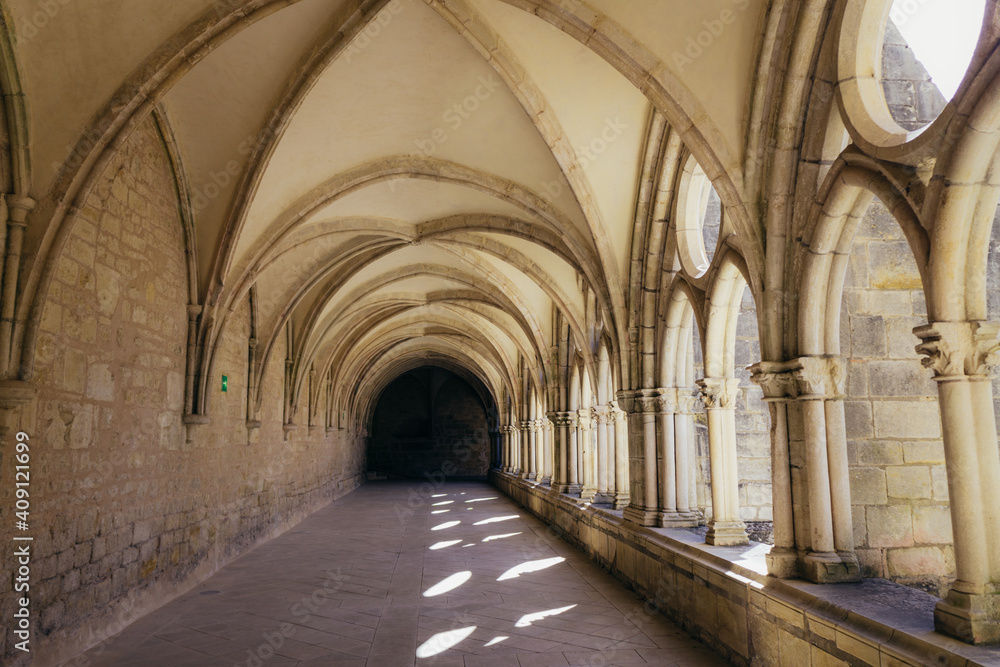 the alley of the gothic cloister of the Noirlac abbey, a monastery situated in Berry region (France)