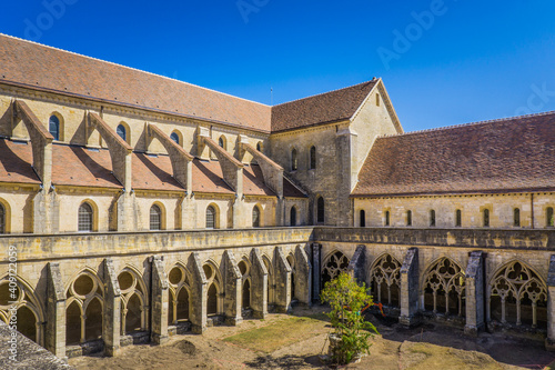 View on the cloister and the church of the Noirlac abbey, a beautiful gothic monastery in Berry region, France photo