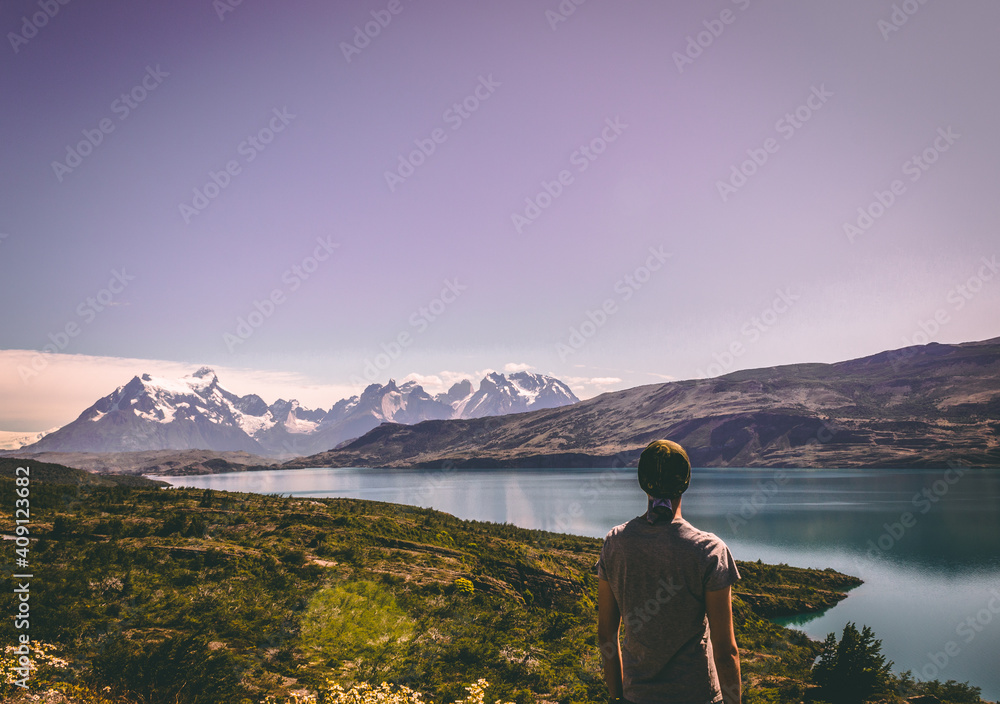 Fototapeta premium Person on a hill. View of the Torres del Paine national park. Patagonia, Chile, South America.