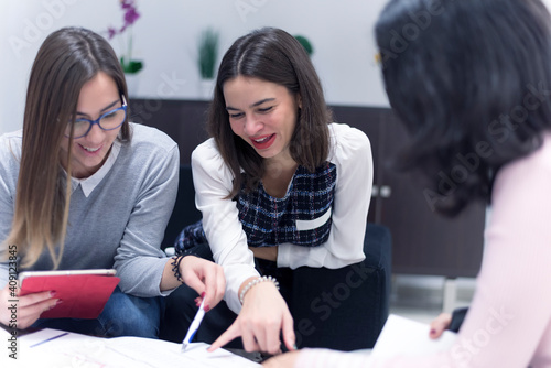 Focused multi national students studying together, team of girls and guys  helping eachother with school work understanding, share ideas, offers creative approach to solve  challenge concept photo