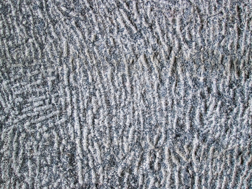Stone texture with lines and depressions. Gray background with stone pavement.