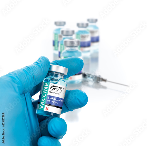 Doctor or Nurse Wearing Surgical Glove Holding Coronavirus COVID-19 Vaccine Vial