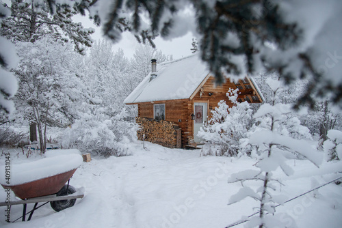 A wooden cabin in a snowy winter landscape