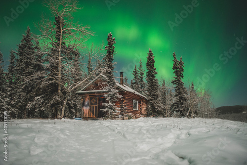 Wooden cabin under the Northern Lights