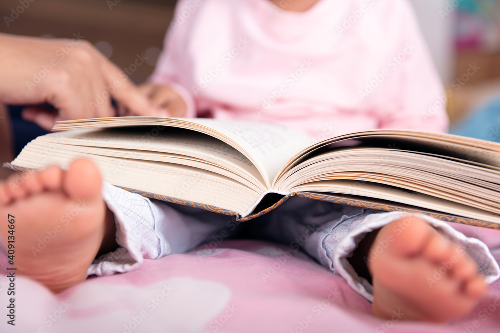 Close up of a child with a book on his lap Close up of a child with a book on his lap