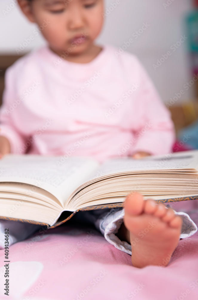 Close up of a child with a book on his lap Close up of a child with a book on his lap