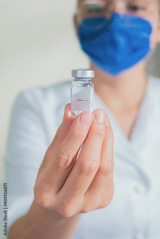 Nurse showing a medical sample container Nurse showing a medical sample container