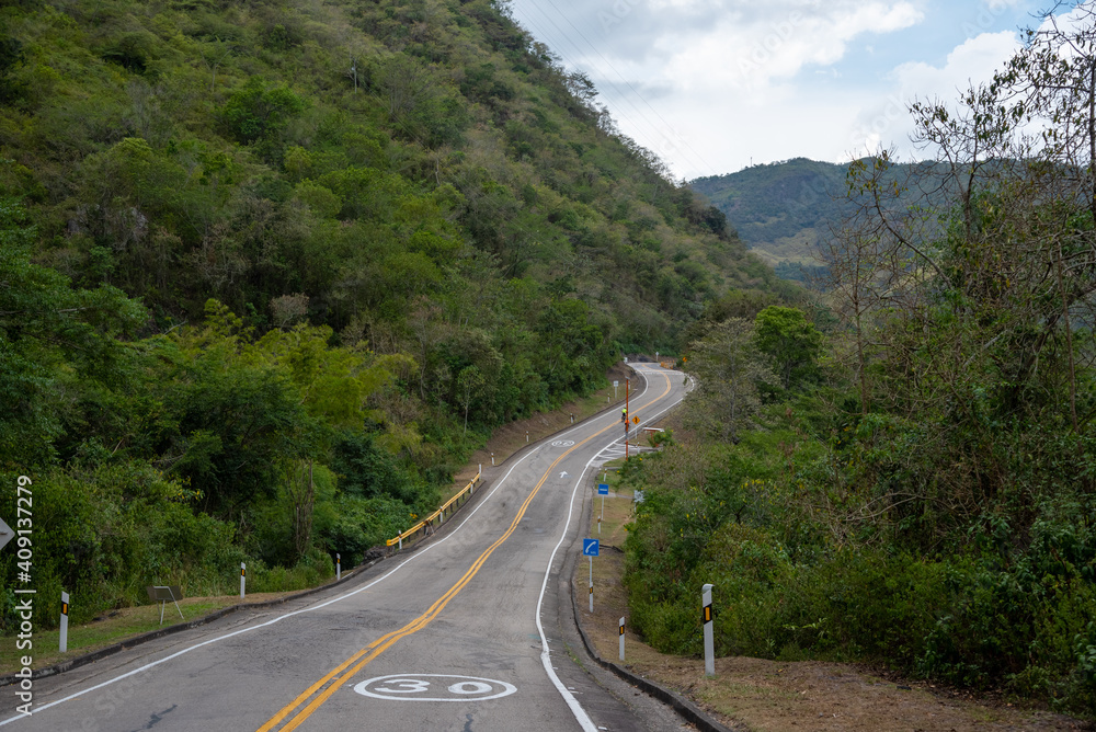 Highway in Colombian countryside with several curves in a humid and warm climate