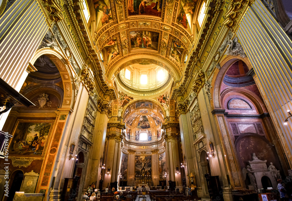 The golden, ornately decorated interior napse, pews, dome and apse of the Basilica of Sant'Andrea della Valle in Rome, Italy.