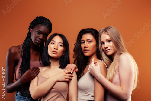 SaveDownload Previewyoung pretty asian, caucasian, afro woman posing cheerful together on brown background, lifestyle diverse nationality people concept
