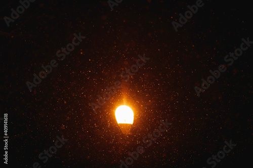 street lamp light at night with snow particles