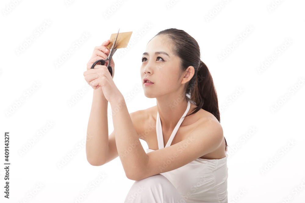 Fashionable young woman cut bank card Fashionable young woman cut bank card