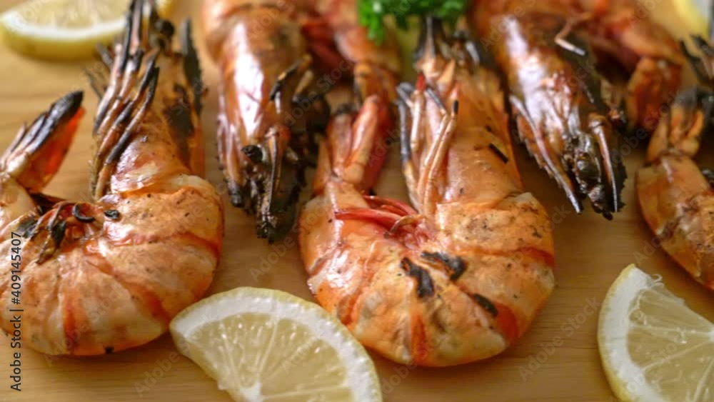 grilled tiger prawns or shrimps with lemon on wood board grilled tiger prawns or shrimps with lemon on wood board
