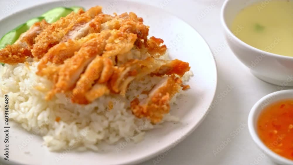 Hainanese chicken rice with fried chicken or rice steamed chicken soup with fried chicken - Asian food style Hainanese chicken rice with fried chicken or rice steamed chicken soup with fried chicken - Asian food style