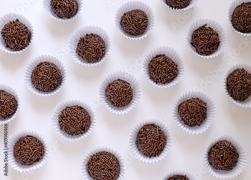 Sweet brigadeiro seen from above on white table.