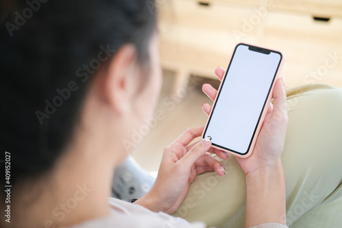 Close up view of business holding mobile phone with blank screen.	