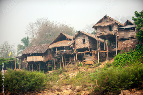 Obraz na płótnie Villages in rural northern Thailand, houses made of wood and bamboo on the hills, misty morning gives a refreshing view, rustic style houses of Karen people. Famine and poor w salonie