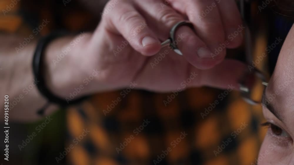 Man barber in plaid shirt makes scissor haircut to young man. High quality 4k footage Man barber in plaid shirt makes scissor haircut to young man. High quality 4k footage