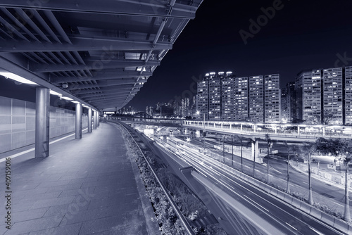 Empty modern pedestrian walkway and traffic in Hong Kong city at night