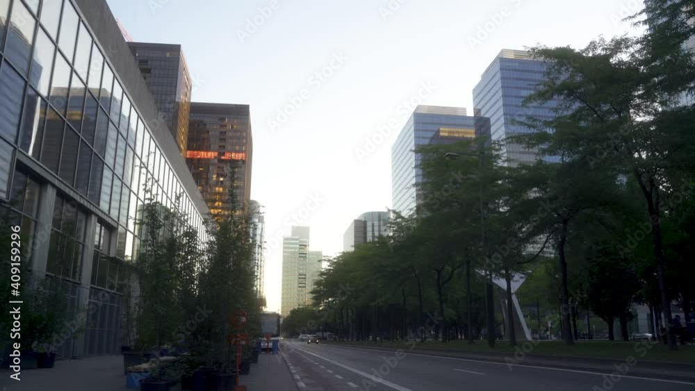 Brussels Nord urban setting with high glass business buildings, during sunrise in the summer with a car coming in the distance. Close to the Brussels north train station. Brussels Nord urban setting with high glass business buildings, during sunrise in the summer with a car coming in the distance. Close to the Brussels north train station.