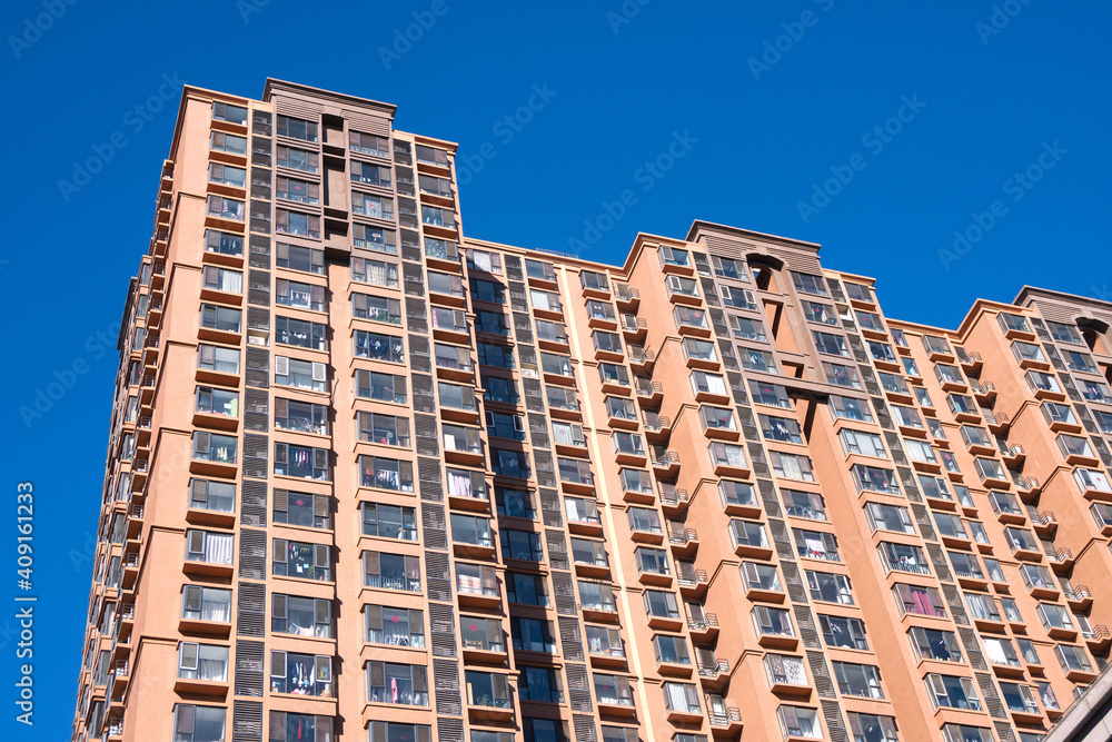 High rise residential buildings under blue sky